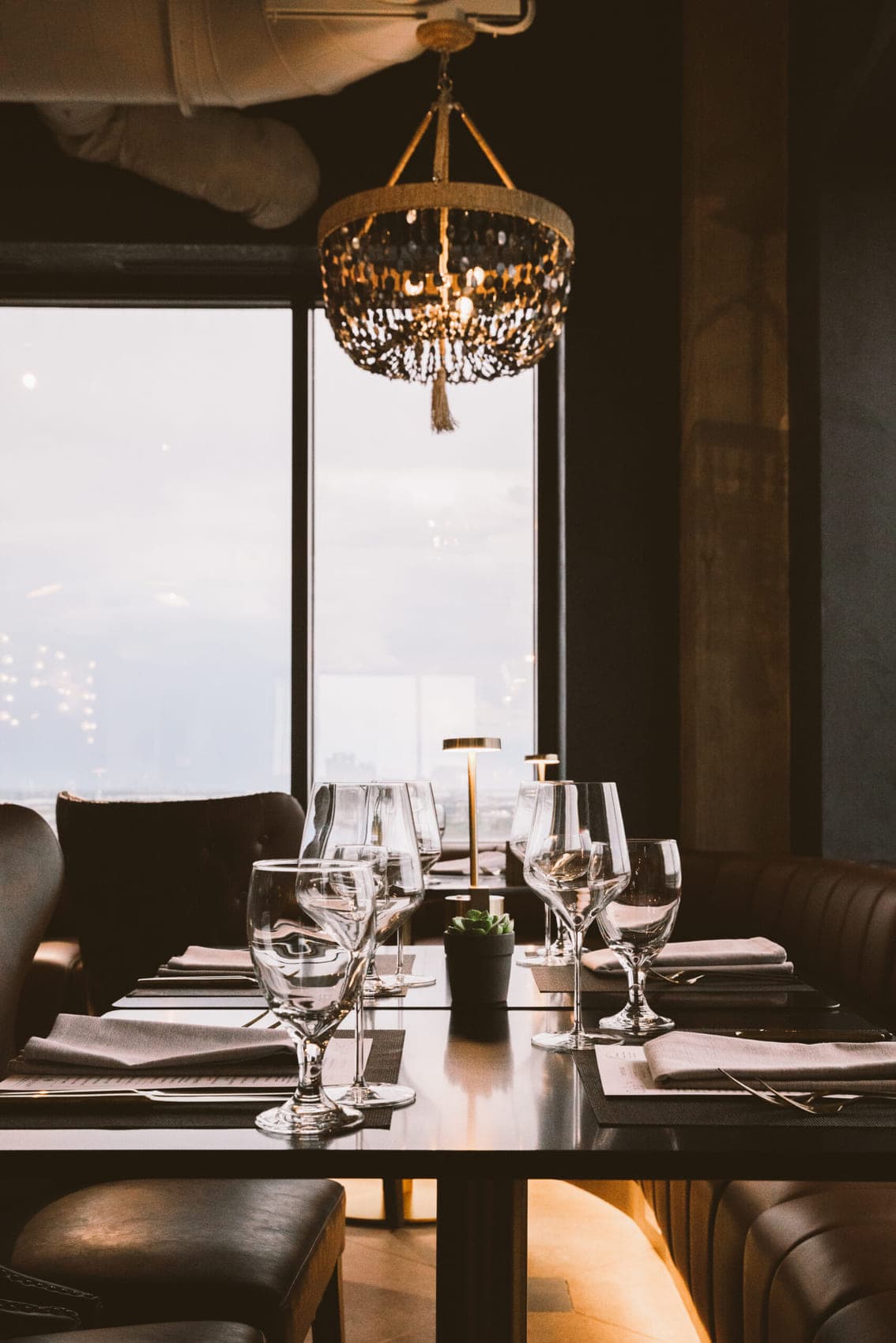 A set table beside the 30th-floor windows